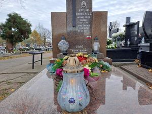 Grób sierżanta Wacława Kundzicza i ustawione na nim znicze w tym jeden z logo komendy powiatowej policji w Rykach