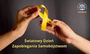dłoń podająca dłoni wstążeczkę napis światowy dzień zapobiegania samobójstwom
