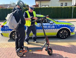 policjant podczas kontroli drogowej kierującego hulajnogą