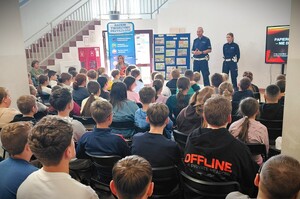Policjant i policjantka prowadza prelekcję dla uczniów